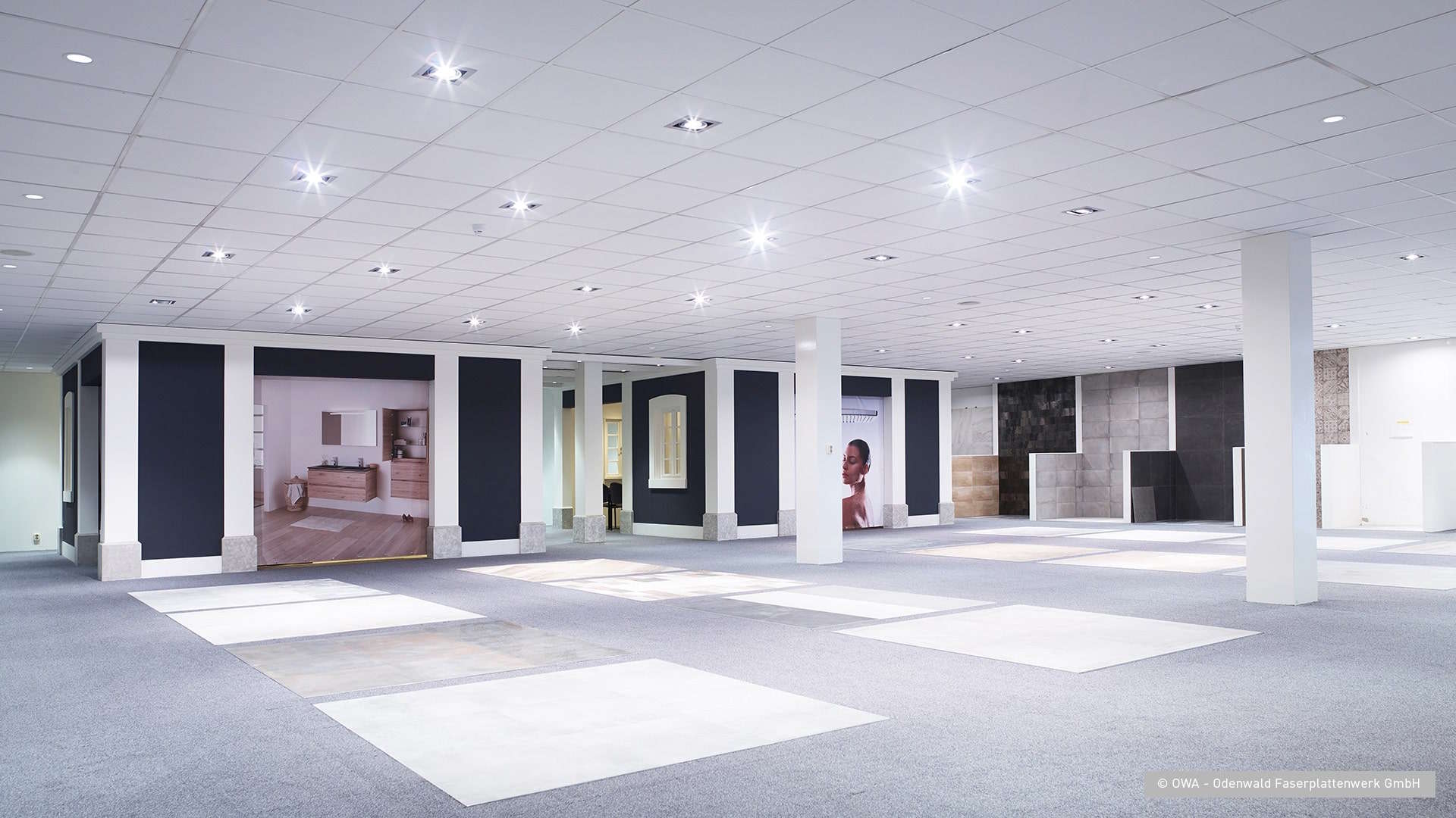 OWA acoustic ceiling tiles installed in modern showroom interior with recessed lighting