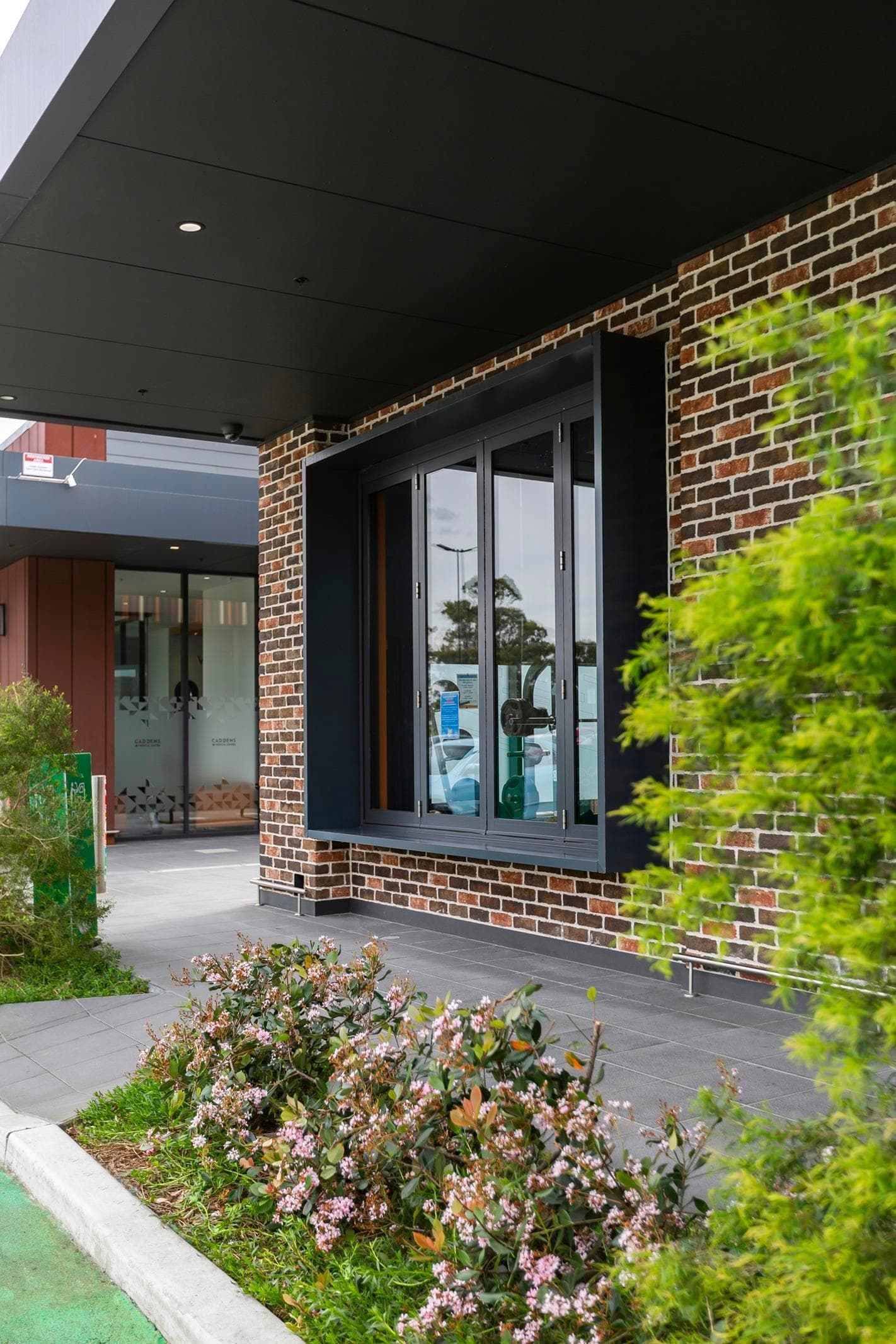 Entry canopy and retail signage framed by ALPOLIC™ NC/A1 cladding