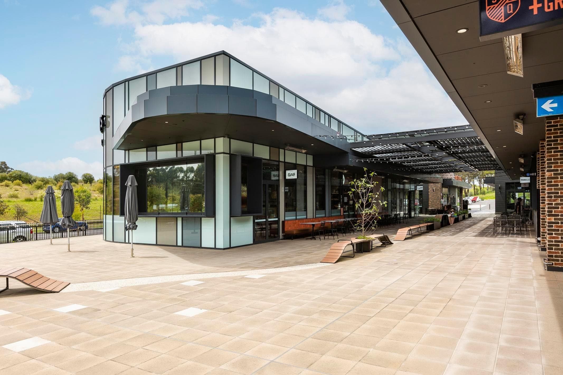 ALPOLIC™ NC/A1 cladding detailing within landscaped retail forecourt