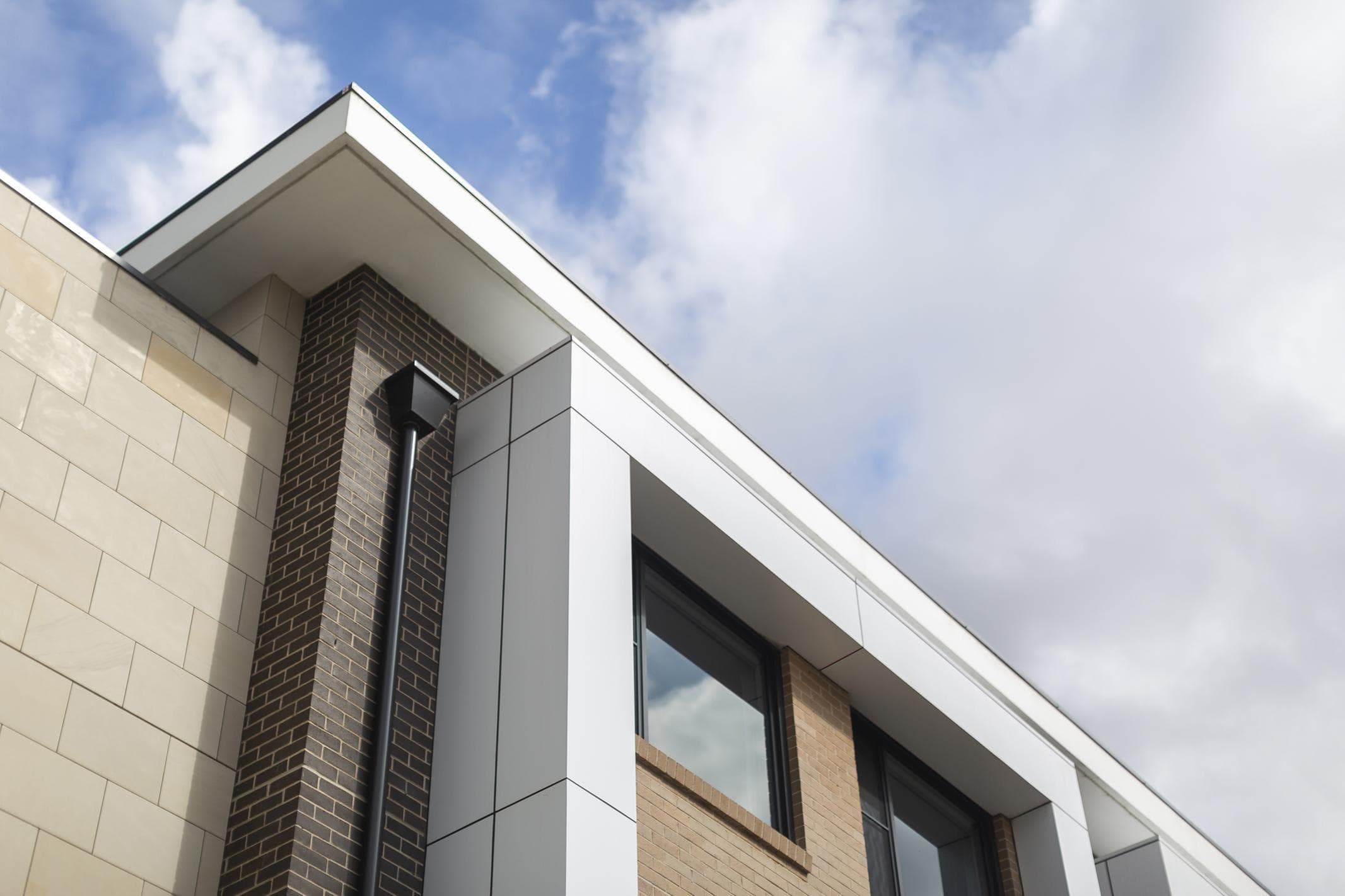Detail of ALPOLIC™ NC/A1 white cladding forming a clean window surround beside brickwork at Oran Park House