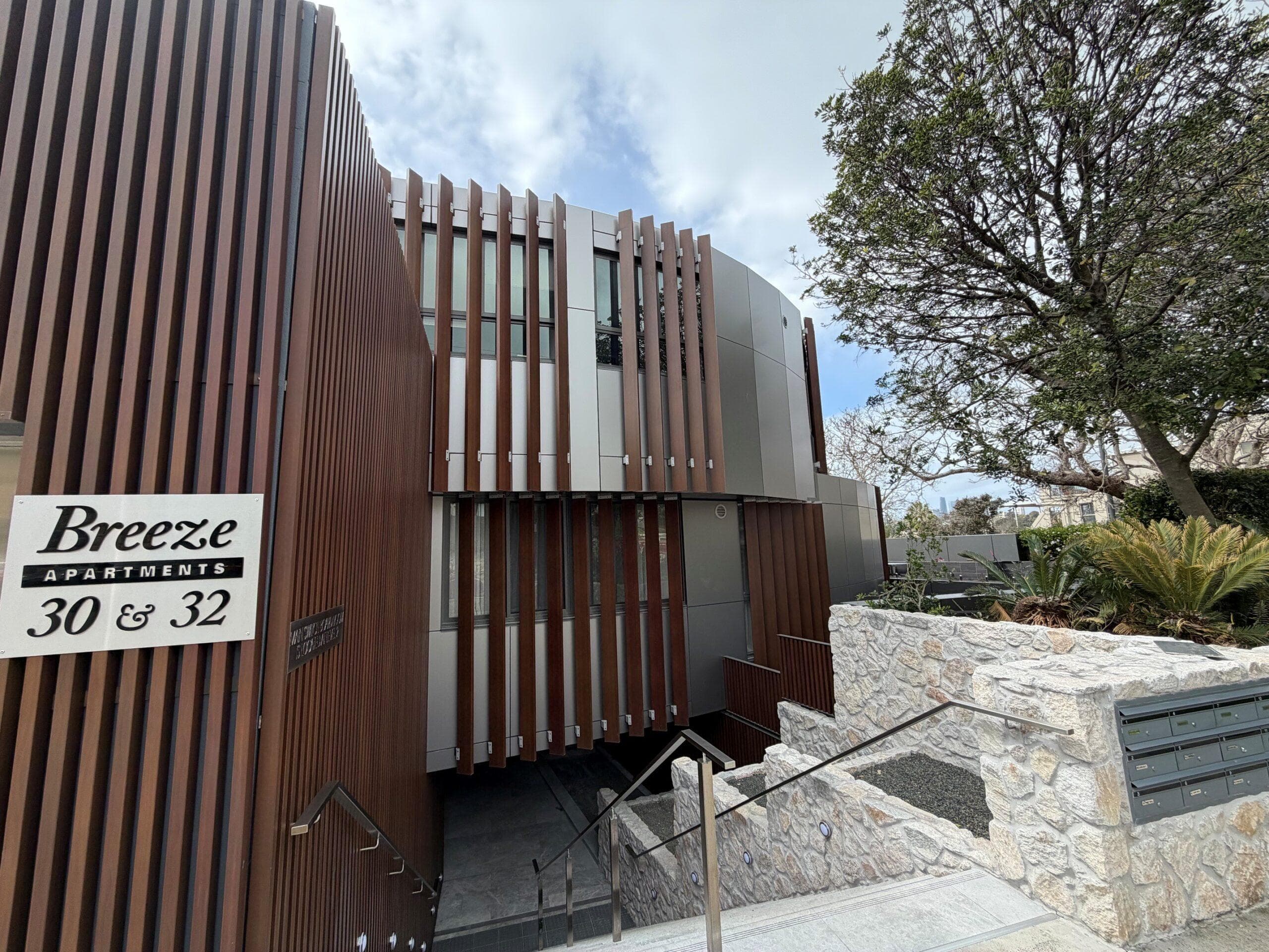 Breeze Apartments entry with ALPOLIC™ NC/A1 façade cladding and vertical timber-look architectural fins