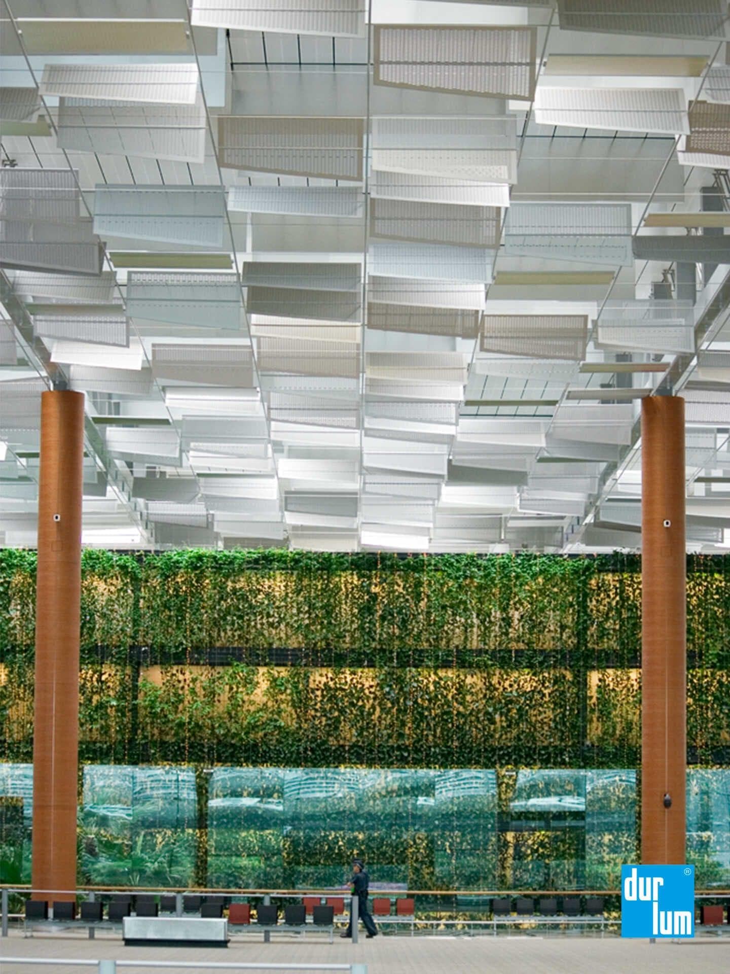 Motorised anodised aluminium butterfly panels within durlum ceiling system at Changi Airport