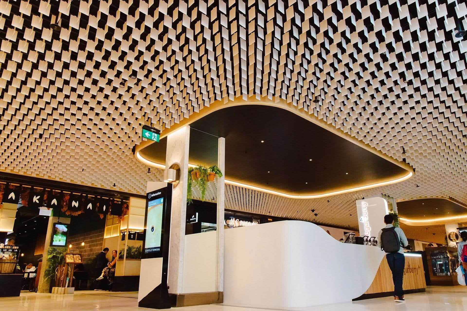 durlum ceiling system with geometric baffles at Castle Towers shopping centre interior