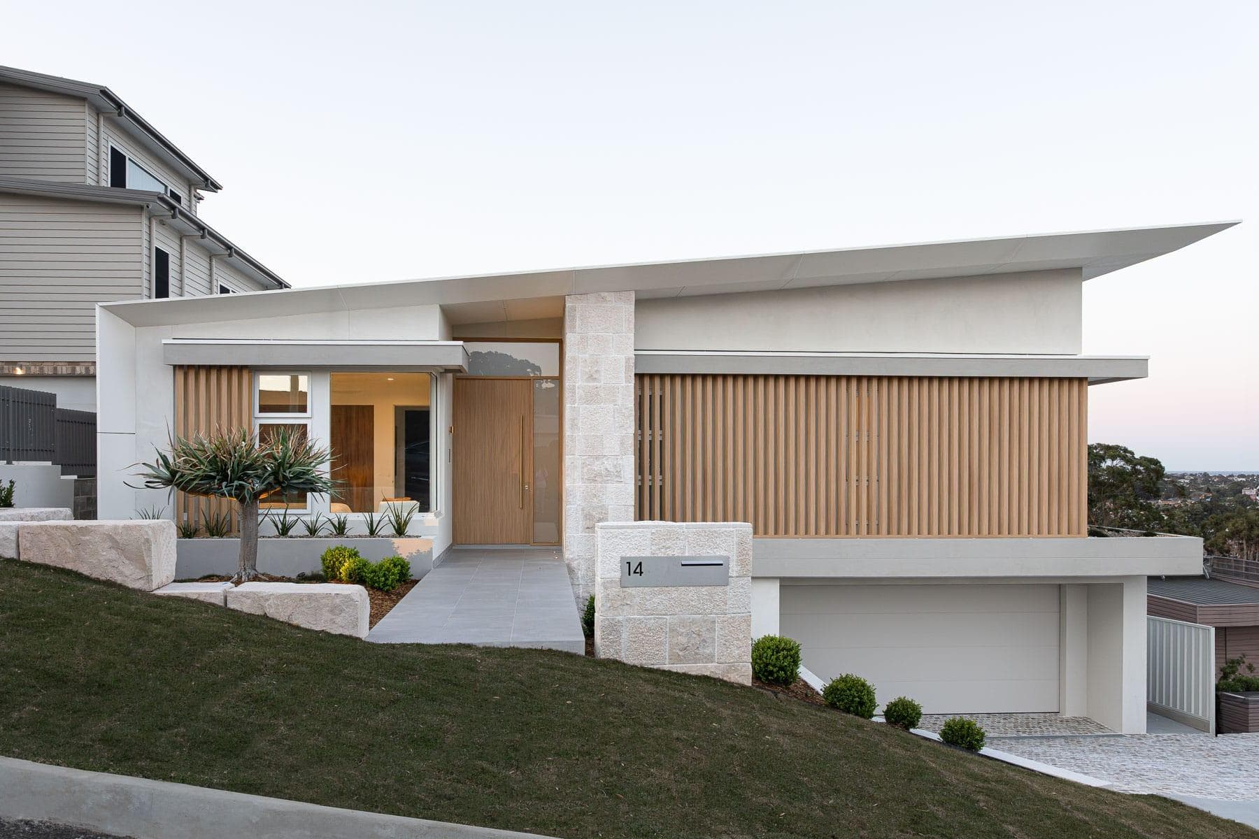 Front elevation of The Horizon in Balgownie NSW at dusk featuring ALPOLIC™ FR Milk White soffits and clean contemporary lines