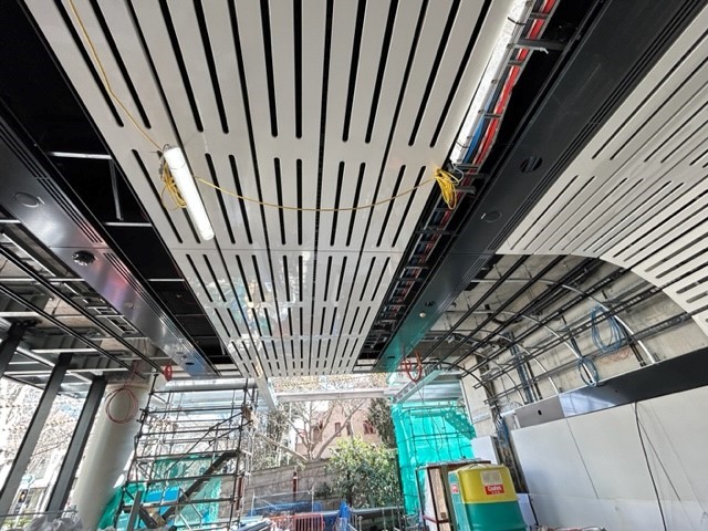 Bespoke Metal Ceiling by durlum being installed in the entrances to Victoria Cross Metro Station