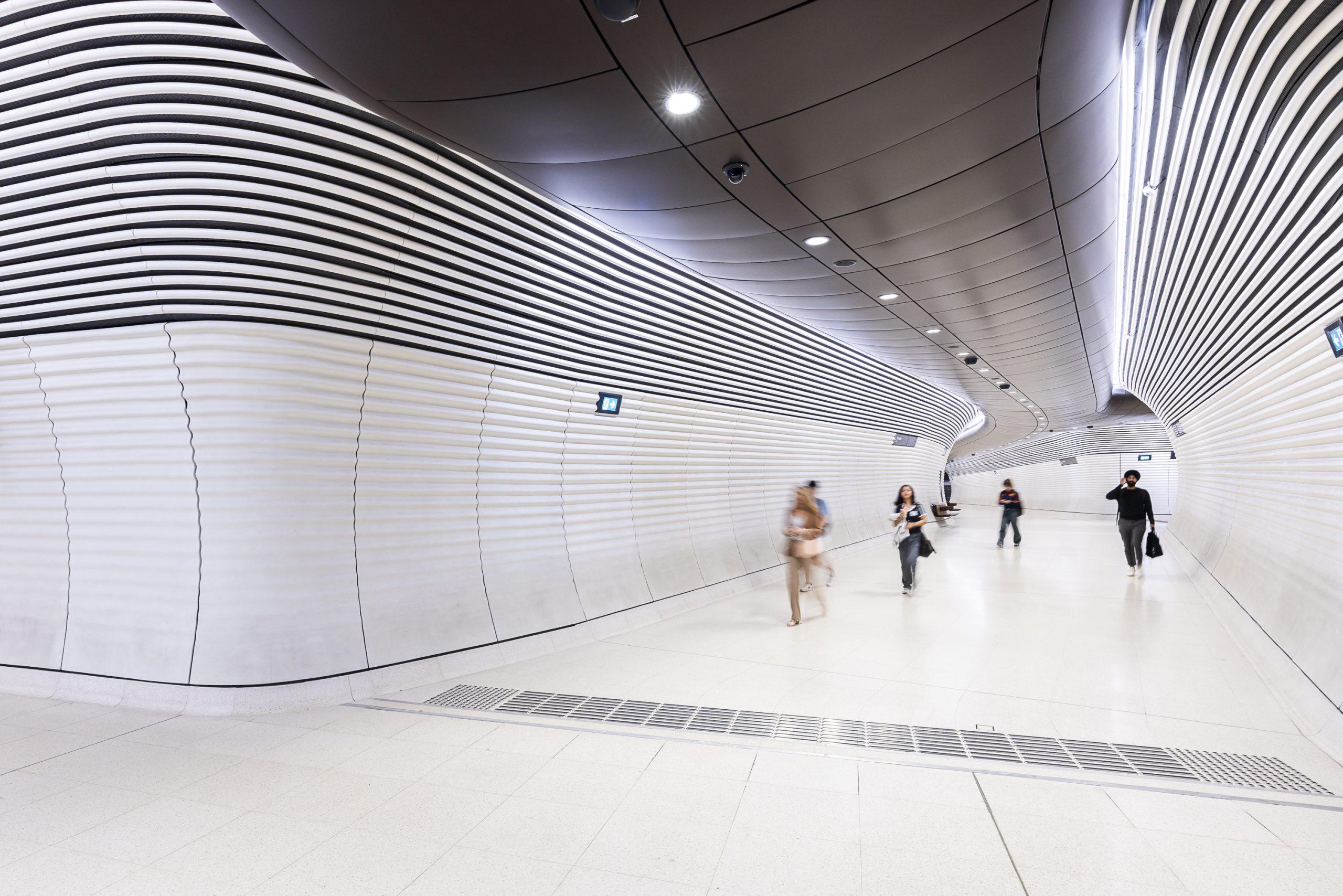 Gadigal Station interior with curved aluminium ceiling and wall panels