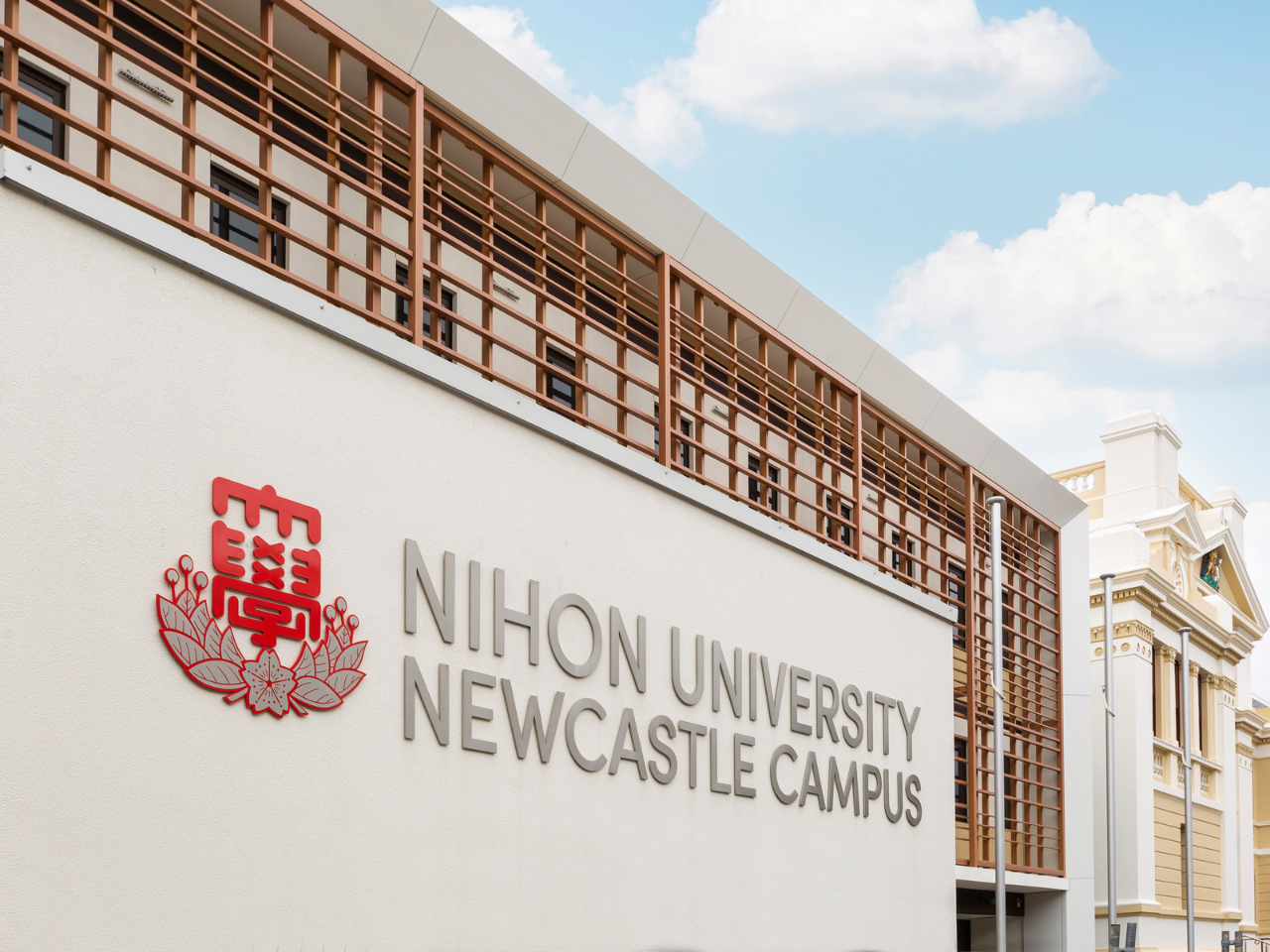 Exterior of Nihon University campus building in Newcastle with distinctive façade design.