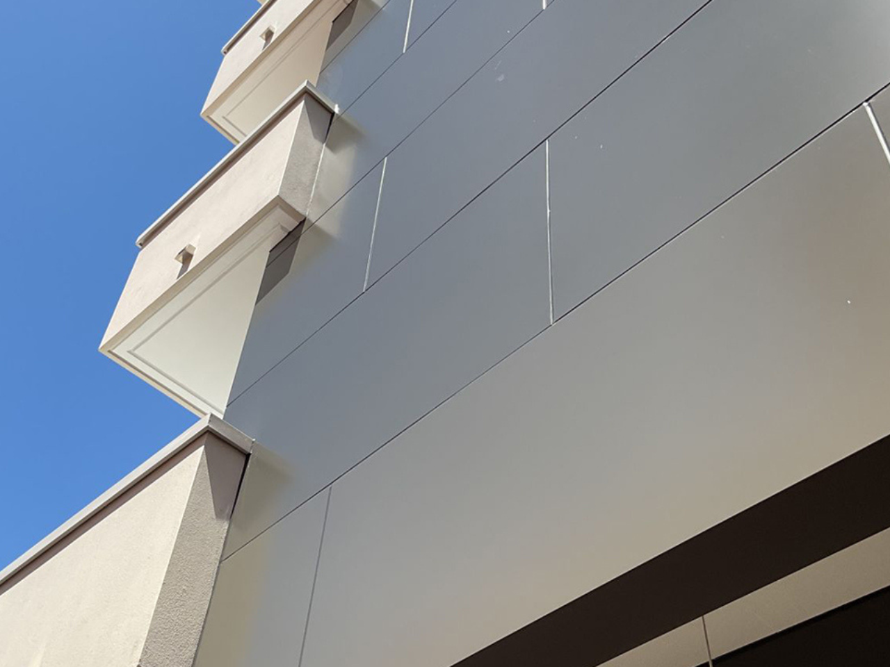 Close-up of non-combustible mineral-core aluminium cladding on the Sandpiper Building façade, Queensland.