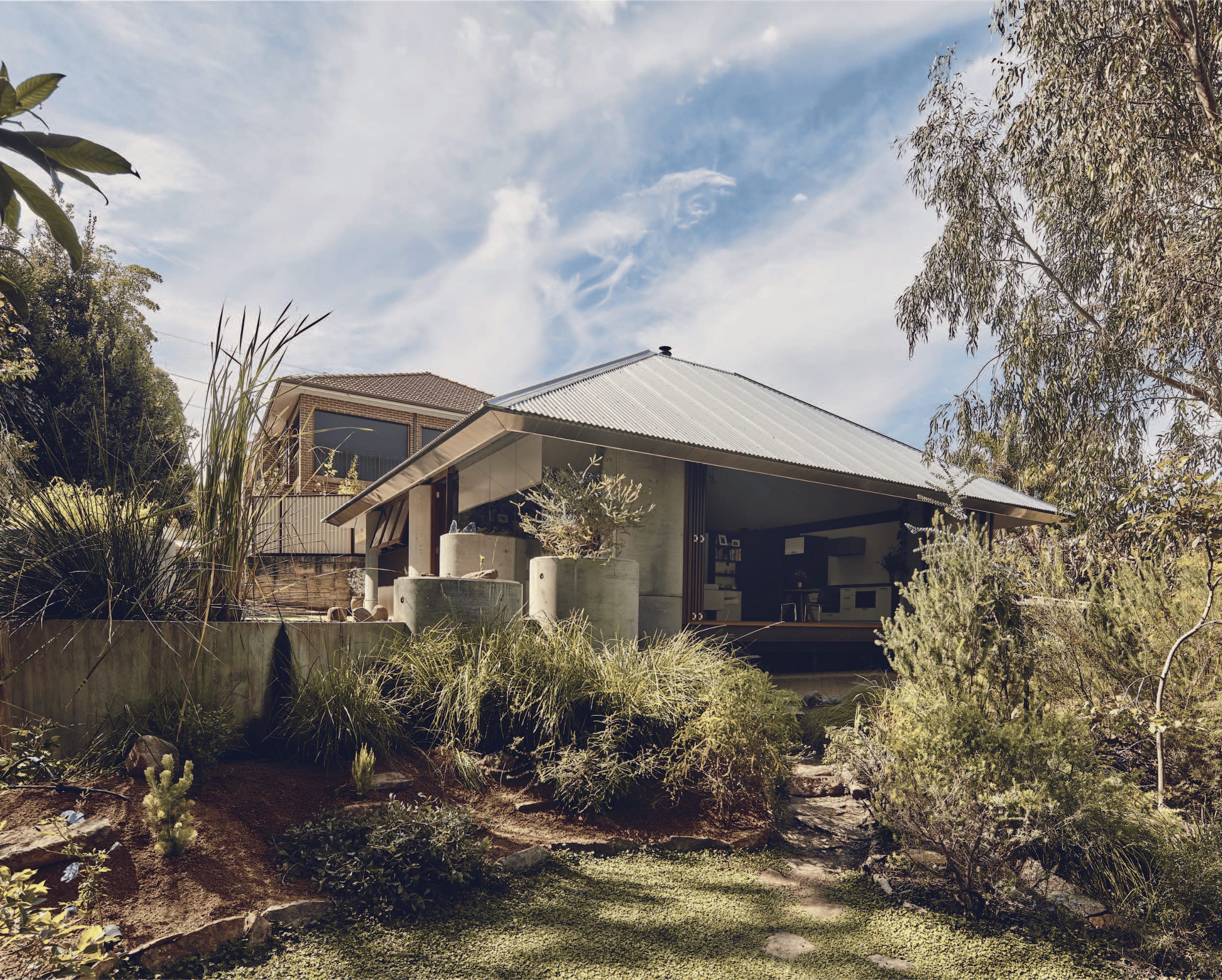 Contemporary residential home featuring ALPOLIC™ fr aluminium cladding integrated with a landscaped natural setting
